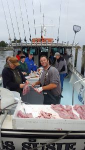 first mate cleans fish on Chesapeake Bay charter boat