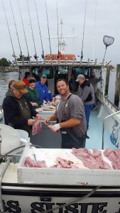 first mate cleans fish on Chesapeake Bay charter boat